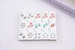 Stocking candy and Christmas tree American Mahjong tiles arranged on white