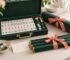 Gift-ready American Mahjong tiles racks and rolled mat in forest green and coral