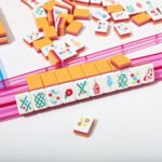 Sunset stripe American Mahjong tiles arranged on a transparent pink rack