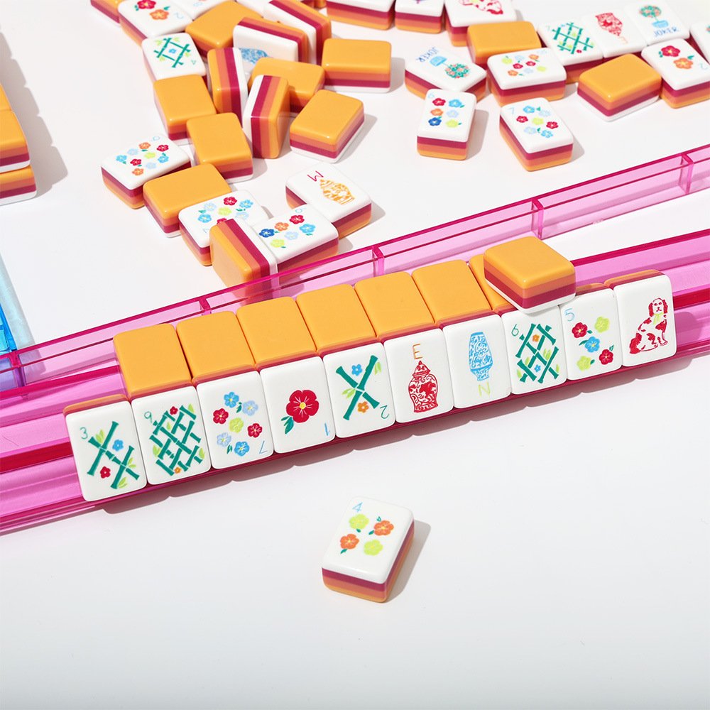 Sunset stripe American Mahjong tiles arranged on a transparent pink rack